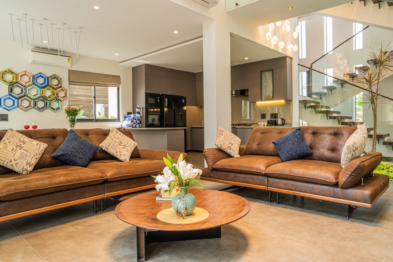 Explore a stylish modern living room with leather sofas and chic decor in a luxury villa.