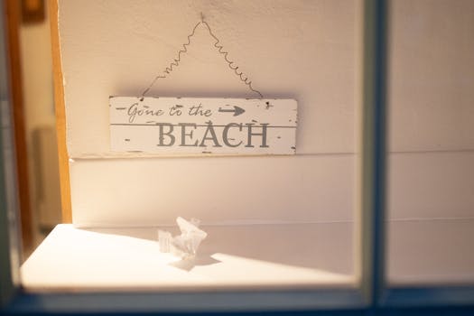Wooden sign reading 'Gone to the Beach' hangs inside with soft lighting.